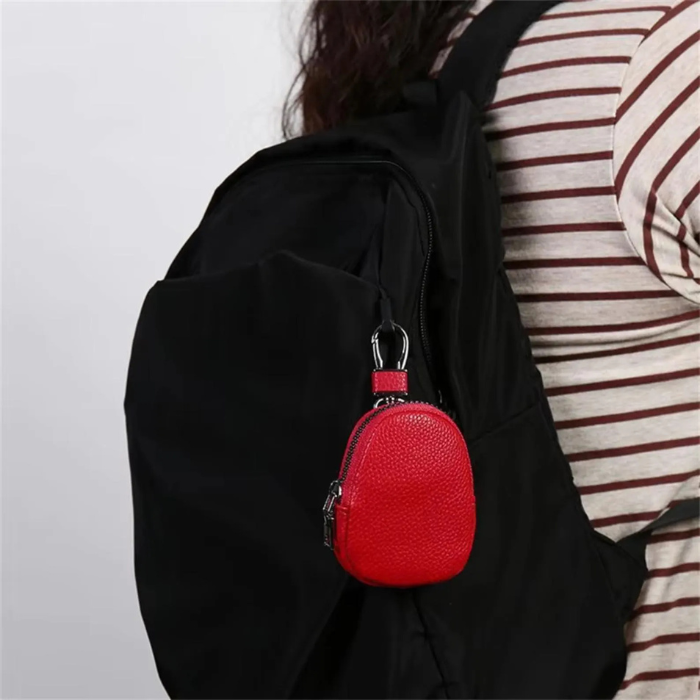 Woman carrying her personalised Coin case in fire red on her bag
