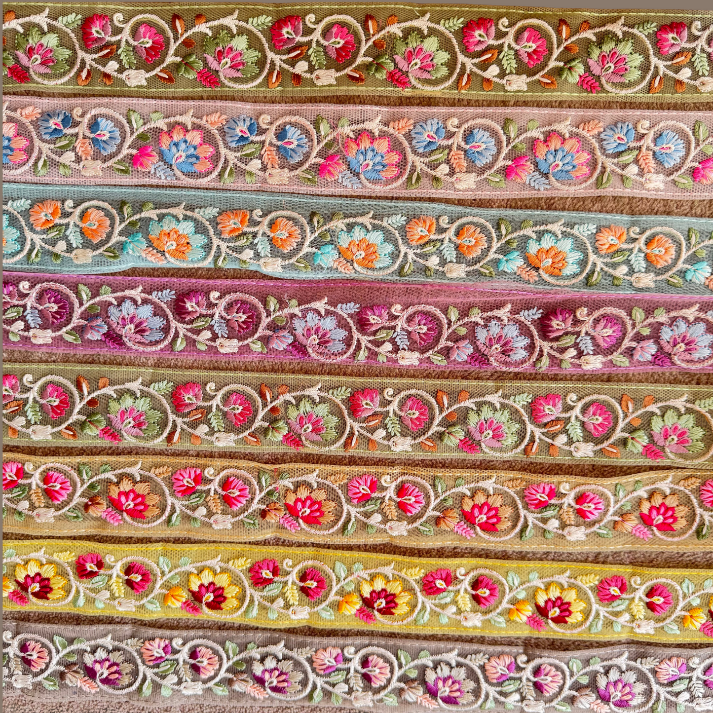Floral Embroidered Net Trim displayed in different colours