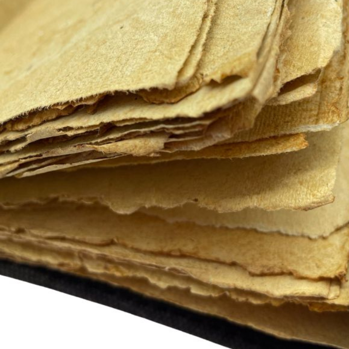 Close up of Kai leather journal vintage with vintage looking deckle edge paper