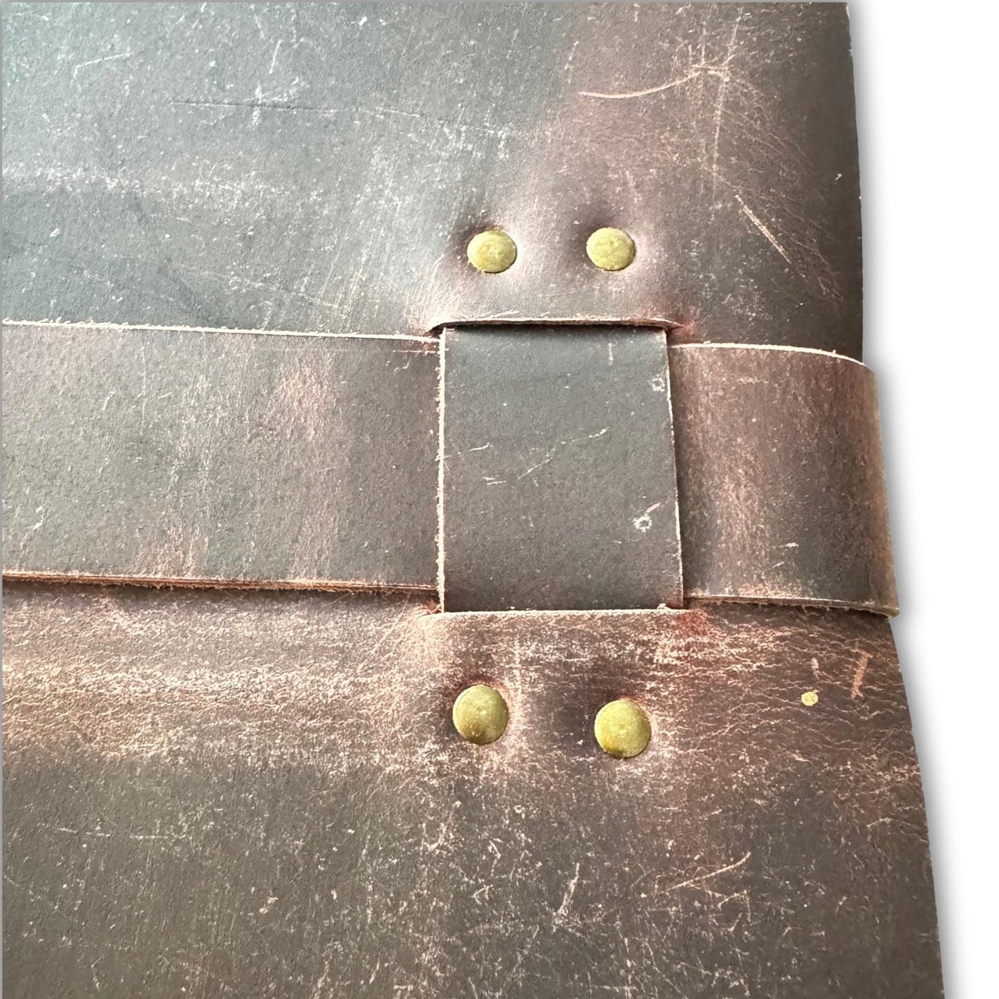 Close up of leather-bound sketchbook with leather strap