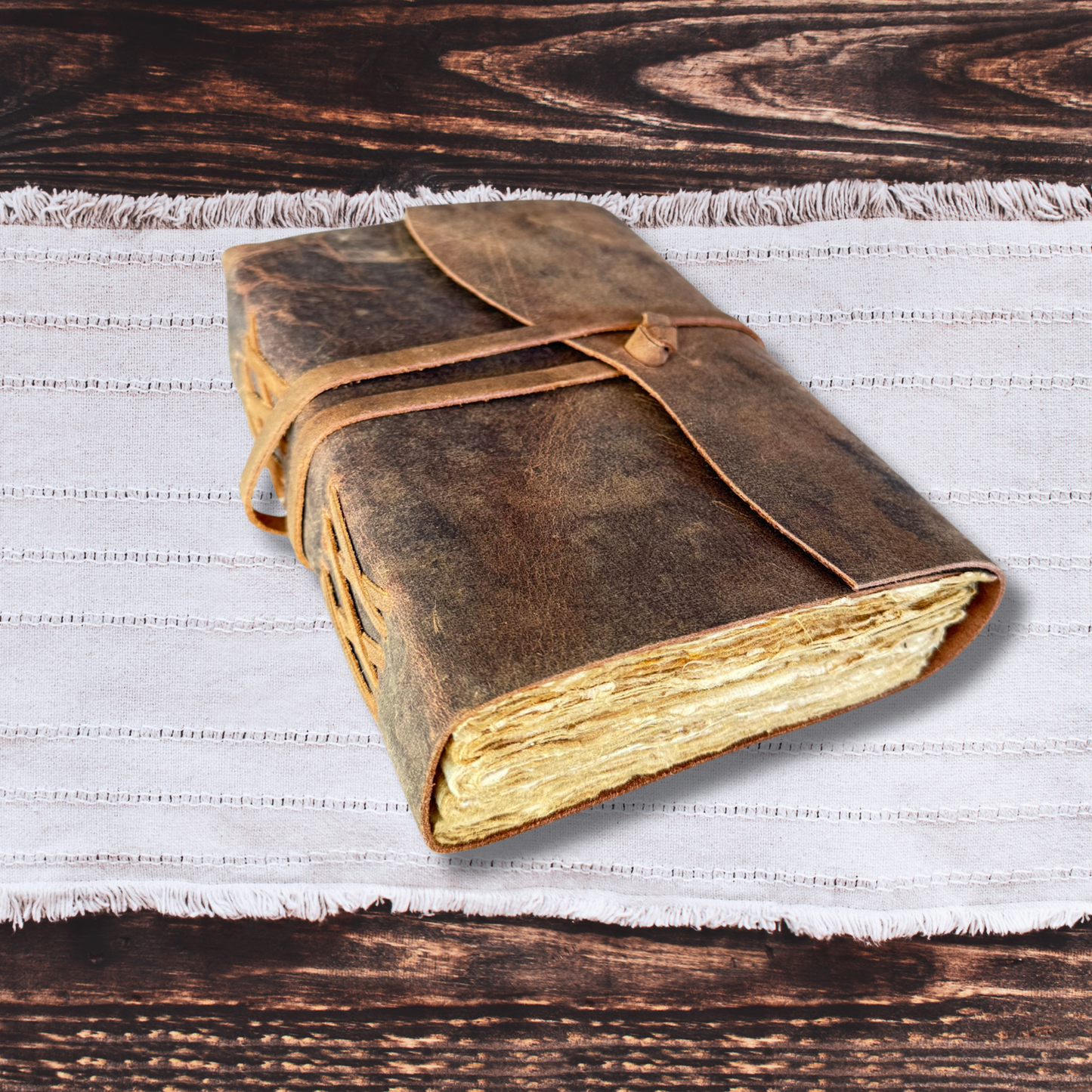 leather journal for men on a wooden background with a white cloth