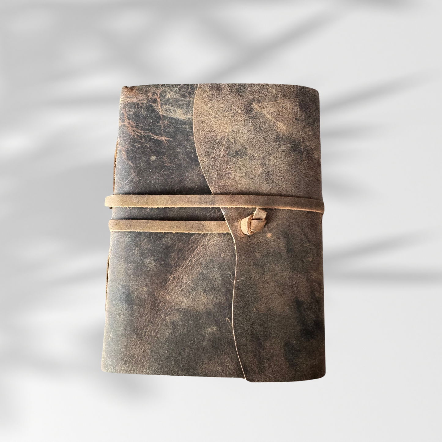 leather journal notebook on a plain white background