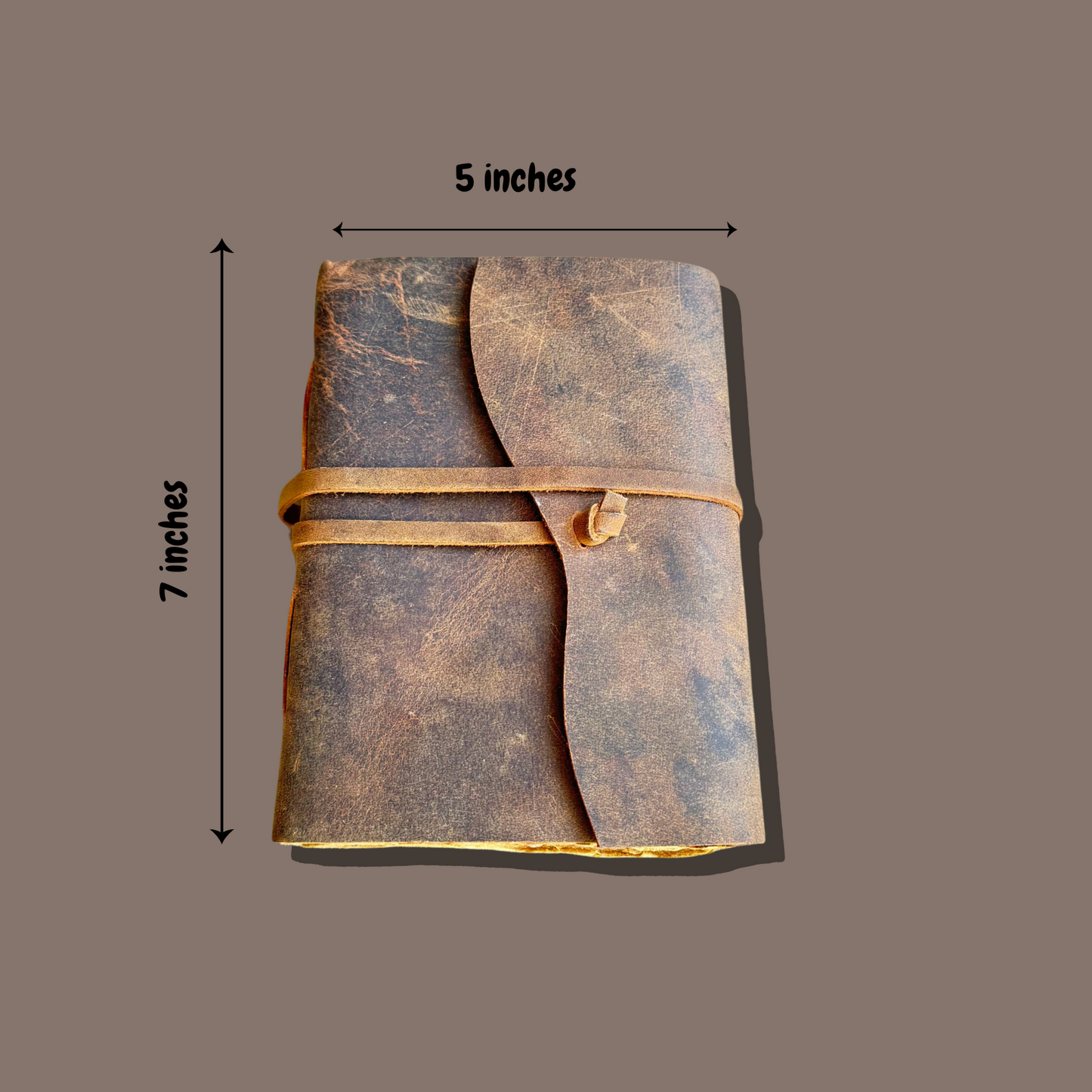 leather journal personalized on a brown background with measurements of the leather journal 5x7 inches.