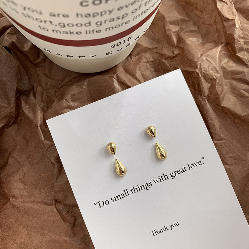  Elsie Gold Teardrop Earring on white paper with a quote