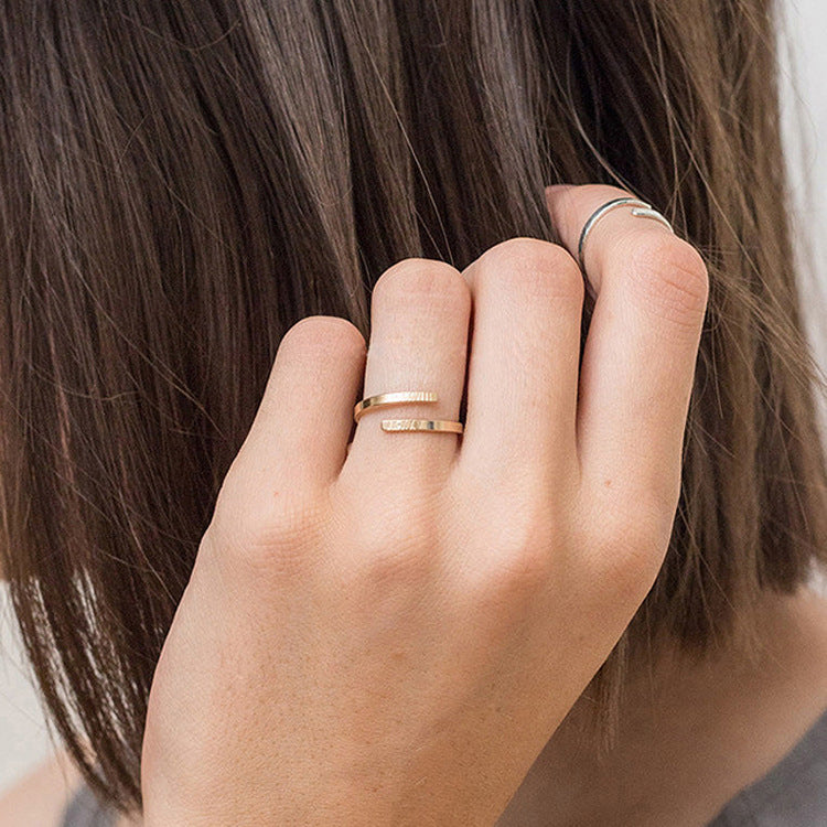 A woman wearing the Giselle personalised ring name in gold with engraving