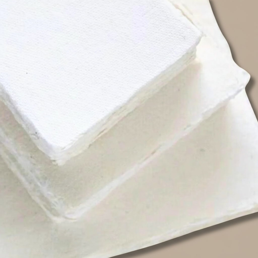 Three stacks of white 250 GSM handmade cotton rag paper with natural deckle edges on taupe background, available in A4, A5 and card sizes, ships from Melbourne