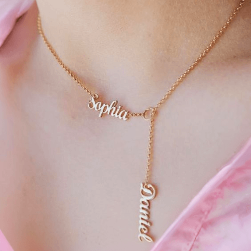 A woman wearing the Alessia Personalised Name Your Necklace in gold with 2 names Sophia and Daniel