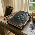 Leather journal with embossed geometric cover and teal stone details, brass corner clasps