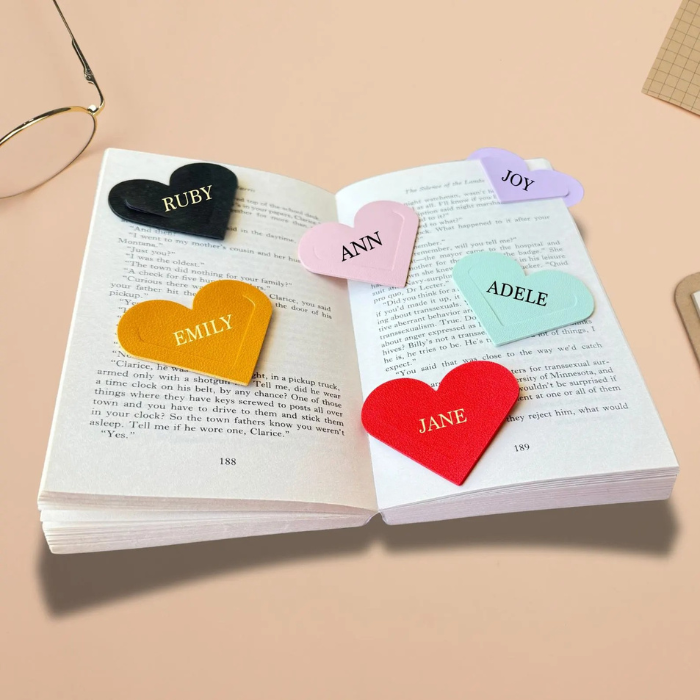 Heart corner bookmark set with pink, black, red, teal and mustard heart tags on open book.