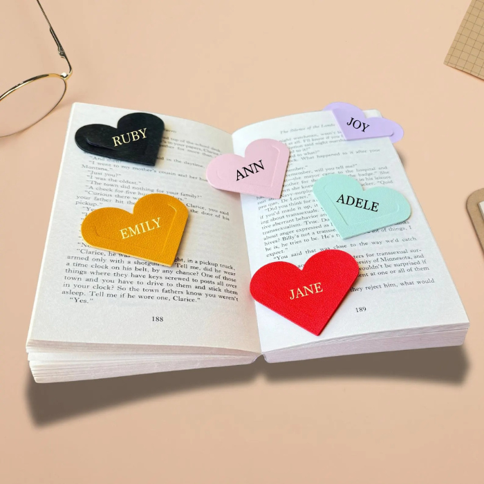 Bookmark heart in 5 colours placed on  a book with an asthetic background