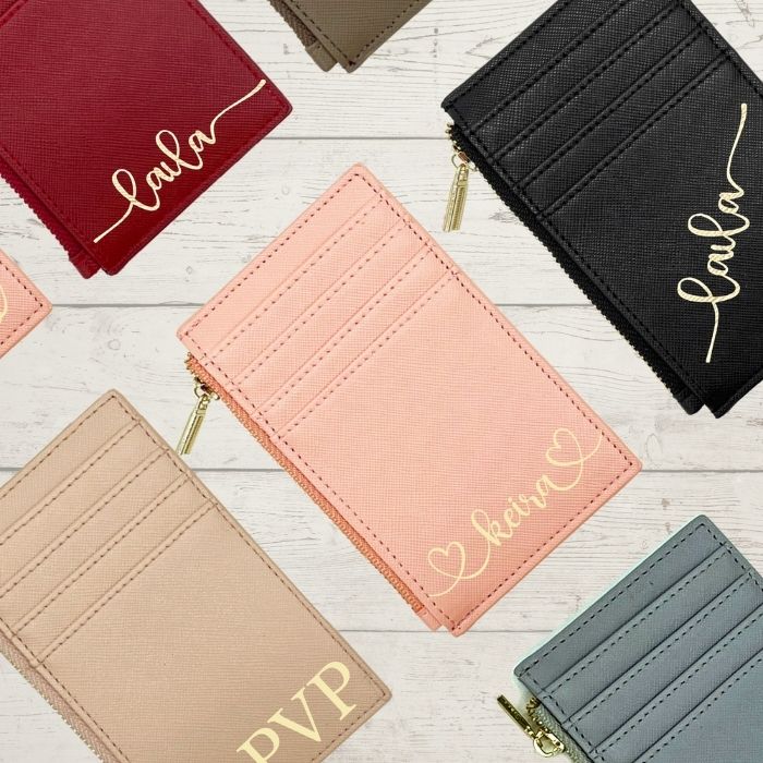 Personalized card wallet assortment with gold zippers and script names, multiple colors