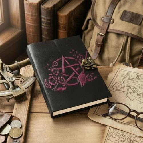 Black leather journal with purple Celtic knot embroidery and brass clasp, angled view