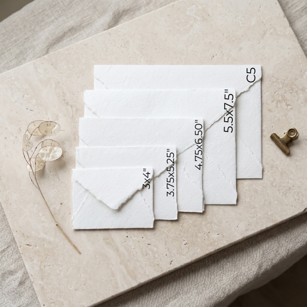 Close-up of deckle edge handmade paper envelopes with textured cotton paper surface, perfect for wax seals and calligraphy pen addressing.