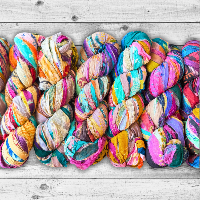 Embroidered Silk Chiffon Ribbon 100g Multicolor on a grey wooden background