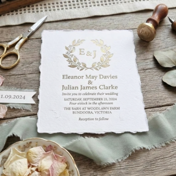 Gold foil printed wedding invitation on 300 GSM handmade deckle edge cotton paper, styled with gold scissors and wax seal stamp — luxury wedding stationery Australia
