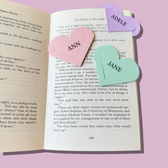 Personalised 3 corner heart bookmarks placed on a book