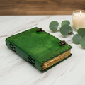 Green leather journal with tree of life embossing, brass clasp and stitched edges