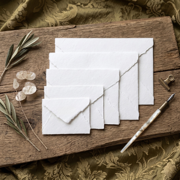  Handmade paper envelopes displayed in multiple sizes — 3x4, 3.75x5.25, 4.75x6.5, 5.5x7.5 and C5 — crafted from genuine handmade cotton paper with deckle edges.