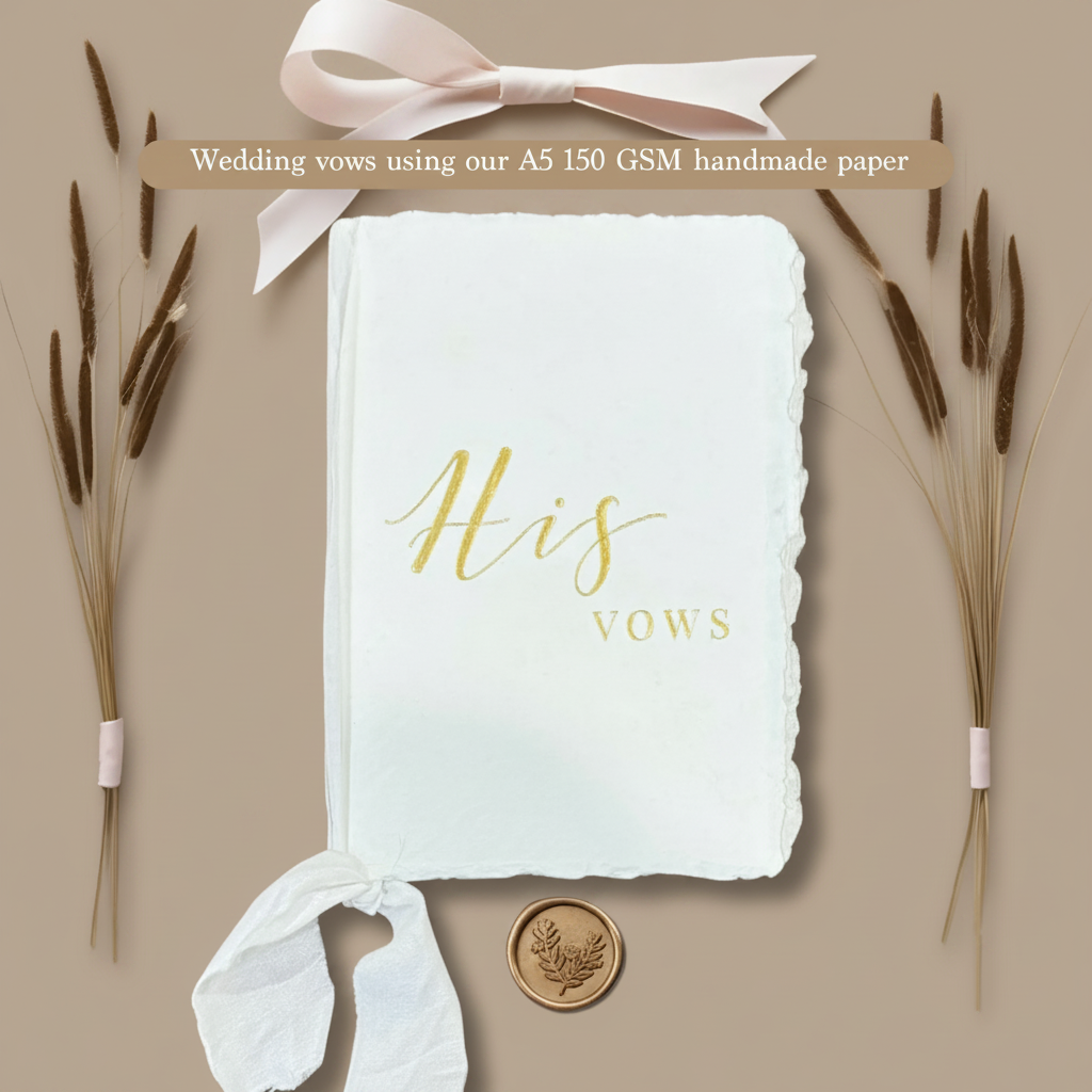 A5 handmade cotton deckle edge paper vow booklet with gold calligraphy His Vows, blush satin ribbon bow, dried pampas grass and gold botanical wax seal on warm taupe background