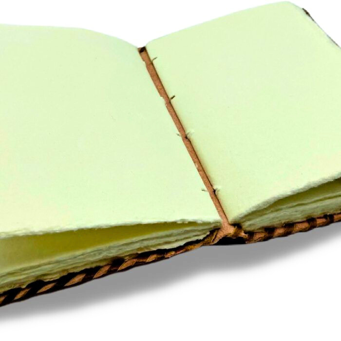 Showing inside of Eske Celtic Leather journal blank with deckle edge handmade cotton rag papers.