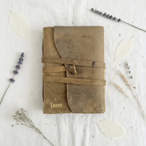 Personalised leather journal with gold embossed name Jane, styled on white linen with dried lavender and pampas grass – leather journal Australia, personalised gift for her