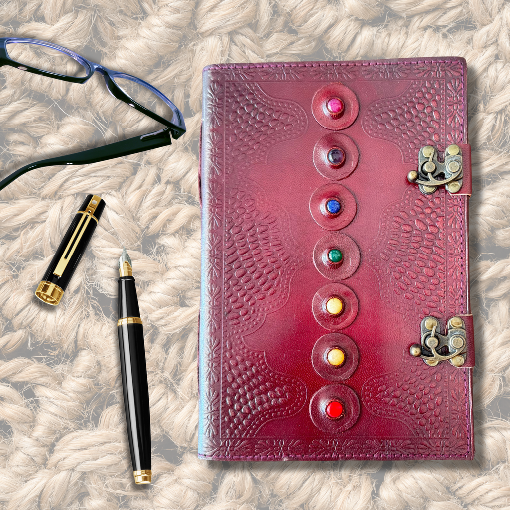 Seven Stone Leather Journal on a jute rug background with galsses and a fountain ink pen on the side of the journal.