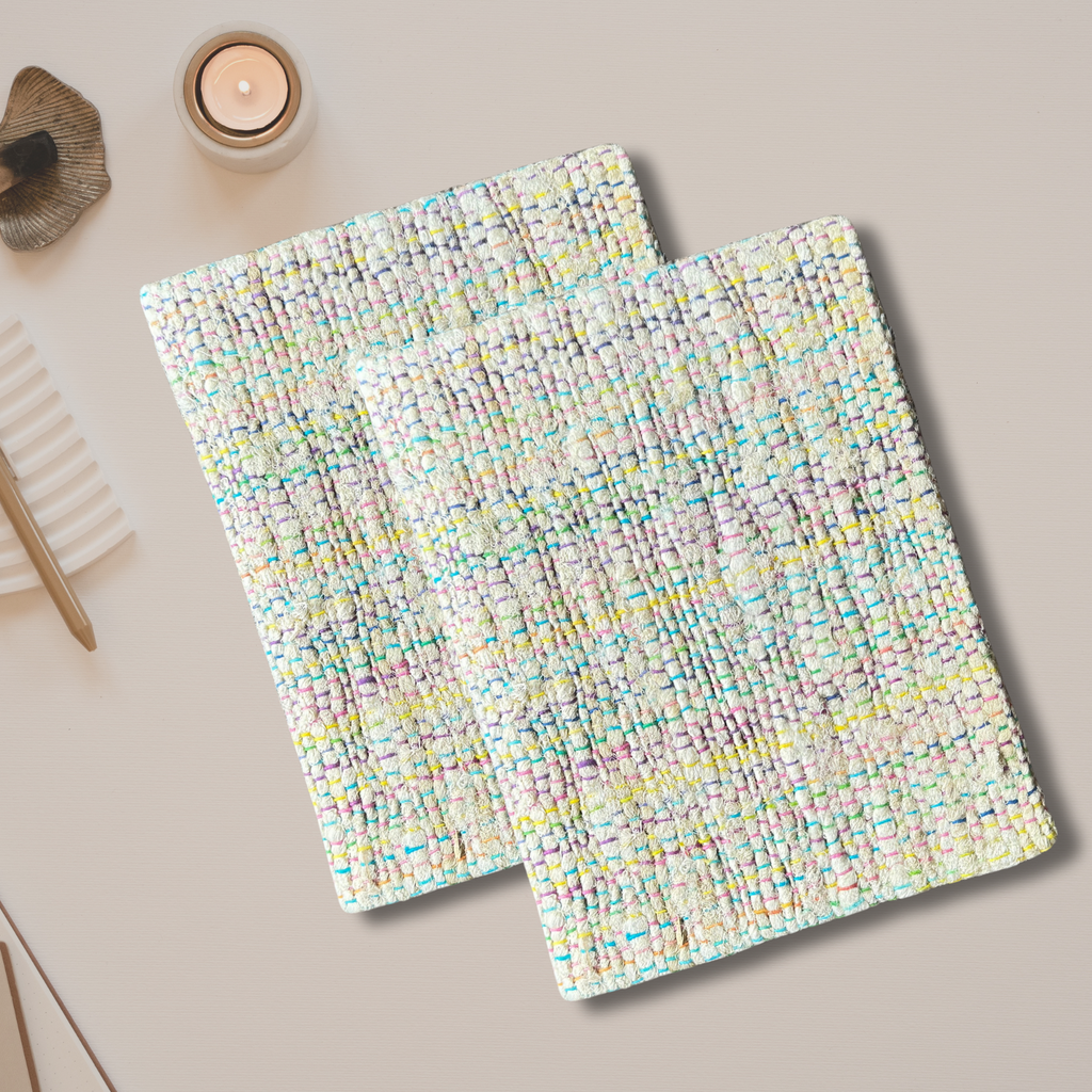 Silk Yarn Notebook on an asthetic background with a small cande burning on the side near the Silk Yarn Notebook
