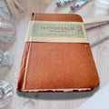 Watercolour Colouring Book on an asthetic table with painitng brushes and water color paint. 