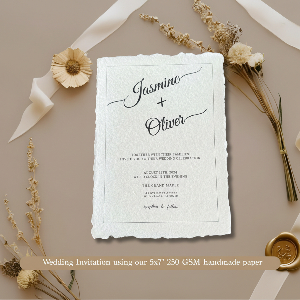 Wedding invitation for Jasmine and Oliver printed on white 250 GSM handmade cotton rag paper 5x7 inch with natural deckle edges, styled with dried flowers, white satin ribbon and gold wax seal on taupe background