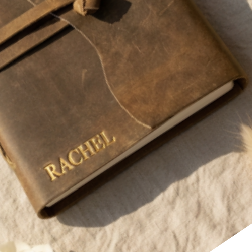Close-up of gold embossed name RACHEL on a premium handmade leather journal 