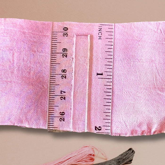 measuring the width of pink sari ribbon  2 inches