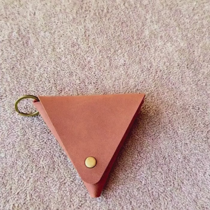 a video showing the use of the brown leather coin bag to store small essentials like coins etc. 