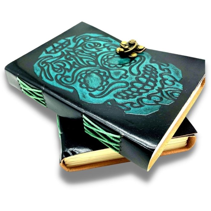 2 scary journals with brass lock placed on top of one another on a white background