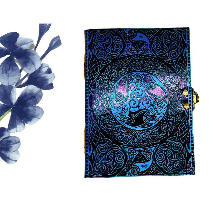 Ezra leather sketchbook on white background with blue flowers on the side
