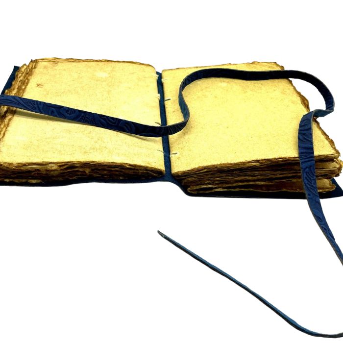 Inside look of Harper Leather journal vintage with vintage looking pages and leather strap to tie the leahter journal.